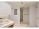 Clean bathroom featuring a shower with glass doors, a tiled floor and a unique tiled window at 7559 S Ivanhoe Cir, Centennial, CO 80112
