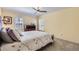 Bright bedroom with neutral walls, white plantation shutters, and a ceiling fan for added comfort at 7559 S Ivanhoe Cir, Centennial, CO 80112