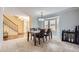 Bright dining area featuring a bay window, with classic chair rail and chandelier, creating an elegant ambiance at 7559 S Ivanhoe Cir, Centennial, CO 80112