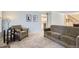 Comfortable living room with neutral carpet and a stylish sofa, ideal for relaxing and entertaining guests at 7559 S Ivanhoe Cir, Centennial, CO 80112