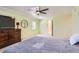 Comfortable main bedroom with a ceiling fan, natural light, and ample space for a relaxing retreat at 7559 S Ivanhoe Cir, Centennial, CO 80112
