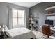 Stylish bedroom features large window, grey accent wall, modern shelving, and desk setup at 1440 Little Raven St # 202, Denver, CO 80202