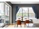 Bright dining area with modern chandelier, natural light, and urban views at 1440 Little Raven St # 202, Denver, CO 80202