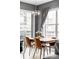 Cozy dining area with modern lighting fixture, city views, and sleek table setting at 1440 Little Raven St # 202, Denver, CO 80202