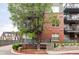 Brick building with balconies and mature tree providing shade and curb appeal at 1440 Little Raven St # 202, Denver, CO 80202
