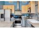 Functional kitchen featuring stainless steel appliances, wood cabinets and light countertops at 1440 Little Raven St # 202, Denver, CO 80202
