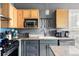 Efficient kitchen featuring stainless appliances, granite countertops, and ample cabinet storage at 1440 Little Raven St # 202, Denver, CO 80202