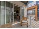 Balcony view showing sliding glass doors leading to a stone fireplace in the adjacent living room at 3142 W 20, Denver, CO 80211