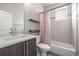 Stylish bathroom featuring a modern vanity and tub with white and red patterned shower curtain at 3142 W 20, Denver, CO 80211