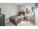 Cozy bedroom featuring a wood-frame bed with storage drawers and a window with natural light at 3142 W 20, Denver, CO 80211