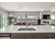 Kitchen island view featuring stainless steel sink, dining, and fireplace at 3142 W 20, Denver, CO 80211