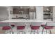 Modern kitchen boasts sleek cabinets, stainless steel appliances, and a spacious island with seating at 3142 W 20, Denver, CO 80211