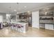 Open-concept kitchen with stainless steel appliances, island with seating and desk area at 3142 W 20, Denver, CO 80211