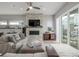 Bright and airy living room with a stone accent wall, modern fireplace, and access to outdoor space at 3142 W 20, Denver, CO 80211