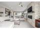 Open-concept living room with a stone fireplace, modern furnishings, and a view into the kitchen at 3142 W 20, Denver, CO 80211