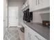 Functional mudroom with white cabinets, a bench, and hanging storage, creating an organized entryway at 3142 W 20, Denver, CO 80211