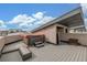 Rooftop deck showcasing a hot tub with a cover, perfect for relaxation and enjoyment of the surrounding cityscape at 3142 W 20, Denver, CO 80211