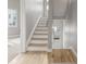 Bright staircase featuring hardwood floors and white risers, leading to the upper level of the home at 3142 W 20, Denver, CO 80211