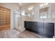 Modern bathroom with walk-in shower, double vanity, and ample storage at 2030 W 66Th Ave, Denver, CO 80221