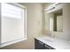 Modern bathroom with vanity, mirror, and window at 2030 W 66Th Ave, Denver, CO 80221