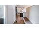 Long hallway with light wood floors, leading to kitchen at 2030 W 66Th Ave, Denver, CO 80221