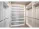 Large walk-in closet with custom shelving and hanging rods at 2030 W 66Th Ave, Denver, CO 80221