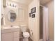 Cozy bathroom featuring a single sink vanity, toilet, and shower, complemented by warm neutral tones and decorative accents at 12819 E Dickensen Pl, Aurora, CO 80014