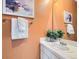 Updated bathroom featuring a modern vanity, large mirror, a plant, and decorative artwork at 12819 E Dickensen Pl, Aurora, CO 80014