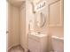 Well-lit bathroom featuring a single sink vanity, toilet, and shower, complemented by warm neutral tones and decorative accents at 12819 E Dickensen Pl, Aurora, CO 80014