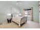 Bright bedroom with large window and a wrought iron bed frame at 12819 E Dickensen Pl, Aurora, CO 80014