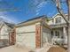 Charming home featuring a two-car garage, brick accents, and a well-maintained front yard at 12819 E Dickensen Pl, Aurora, CO 80014