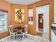 Sunny kitchen breakfast nook shows the passage to bathroom with an attractive Van Gogh print at 12819 E Dickensen Pl, Aurora, CO 80014