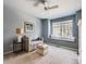 Inviting living room features a window seat, a ceiling fan, a couch and neutral decor at 12819 E Dickensen Pl, Aurora, CO 80014