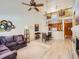 Spacious living room featuring high ceilings and an open floor plan connecting to the dining area at 12819 E Dickensen Pl, Aurora, CO 80014