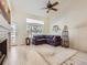 Bright living room with high ceilings, large windows, and a cozy fireplace at 12819 E Dickensen Pl, Aurora, CO 80014