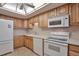 Bright kitchen with wood cabinets and modern appliances at 13601 E Marina Dr # 404, Aurora, CO 80014