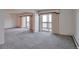 Spacious living room with carpet and access to balcony at 13601 E Marina Dr # 404, Aurora, CO 80014