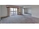 Spacious living room with carpet and access to balcony at 13601 E Marina Dr # 404, Aurora, CO 80014