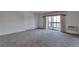 Spacious living room with carpet and access to balcony at 13601 E Marina Dr # 404, Aurora, CO 80014