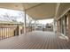 A covered back porch with wooden flooring and black metal railings at 2228 S Eldridge St, Lakewood, CO 80228