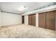 Finished basement area with carpeting, storage closets and neutral paint at 2228 S Eldridge St, Lakewood, CO 80228