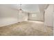 Spacious carpeted basement with two windows, shelving, and classic lighting at 2228 S Eldridge St, Lakewood, CO 80228