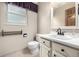 Cozy bathroom features a white vanity with a single sink and tile flooring at 2228 S Eldridge St, Lakewood, CO 80228