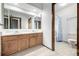 Bathroom features double vanity with wood cabinets, a large mirror, and a separate toilet and shower area at 2228 S Eldridge St, Lakewood, CO 80228