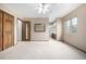 Large carpeted bedroom with wood doors and ensuite bath at 2228 S Eldridge St, Lakewood, CO 80228