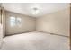 Spacious bedroom with plush carpeting, a ceiling fan, and large window at 2228 S Eldridge St, Lakewood, CO 80228