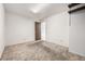 Bedroom with neutral carpet, neutral paint, a closet, and an open doorway at 2228 S Eldridge St, Lakewood, CO 80228