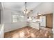 Cozy dining area with hardwood floors, ceiling fan, and an open kitchen layout at 2228 S Eldridge St, Lakewood, CO 80228