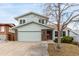 Charming two-story home featuring a brick accent wall and a two-car attached garage at 2228 S Eldridge St, Lakewood, CO 80228