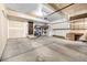 Spacious garage featuring concrete floors, storage cabinets, and shelving at 2228 S Eldridge St, Lakewood, CO 80228